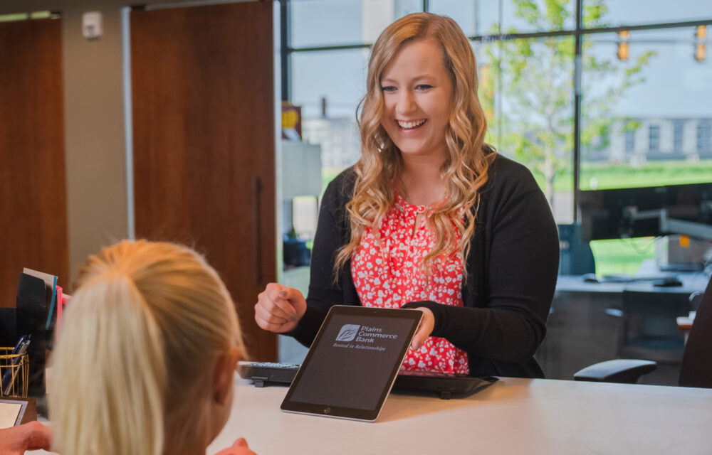 Teller showing her client something on a ipad