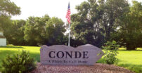 Sign that says Conde, a place to call home in a park