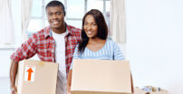 Couple holding moving boxes