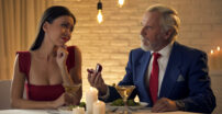 Old Man Proposing To Attractive Young Woman and her not looking enthused