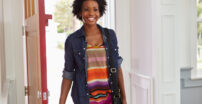 Young woman walking in the front door of her house