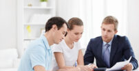 Young Couple Signing Contract while banker helps them