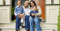 Family sitting on the steps of a house