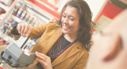 Woman using a credit card at a store