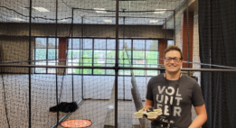 Jacob Hageman holding a drone, smiling at the camera