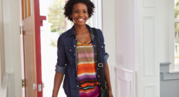 Young woman walking in the front door of her house