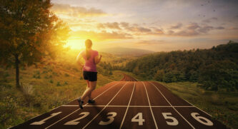 Woman running on a track in the middle of a forest