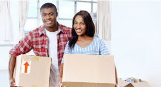 Couple holding moving boxes