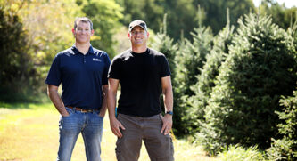 A banker standing next to their client in the outdoors