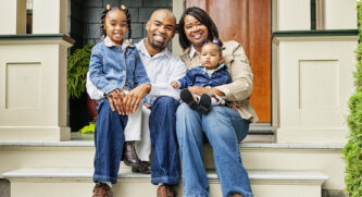 Family sitting on the steps of a house