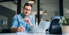 Man reviewing bank account and noting charges